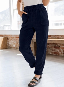 Close-up of deep blue corduroy wide-leg pants showing texture and side pocket detail