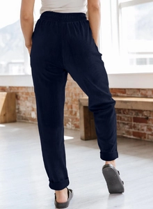 Detail view of high waist corduroy trousers showing the back fit and elastic waistband