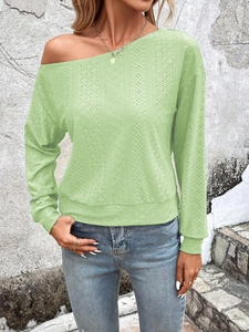 Detail of light green off-shoulder long sleeve top with textured jacquard fabric