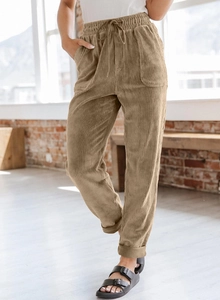 Detail showing elastic drawstring waist and large pockets of khaki corduroy trousers