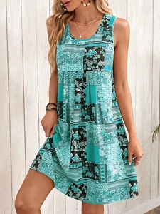 Detail of bohemian sleeveless A-line dress with paisley print and teal patchwork design