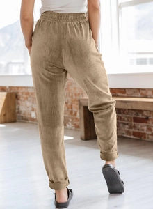 Detail of women's corduroy wide-leg pants with elastic waist and cuffed hems back view