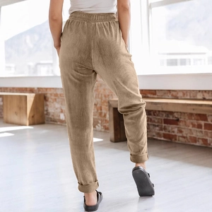 Women casual khaki corduroy wide leg pants with elastic waist and cuffed hem in a cozy room