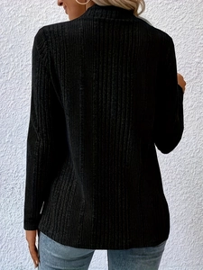 Detail view of black long-sleeve knit cardigan featuring textured pleated fabric and slim fit