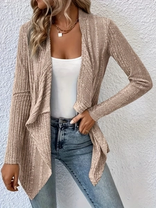 Detail of beige ribbed knit cardigan featuring long sleeves and an irregular hemline
