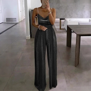 Close-up of elegant black sequin jumpsuit featuring beaded straps and deep V-neckline detail