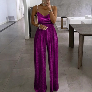 Detail of purple metallic pleated jumpsuit featuring pearl beaded straps and V-neckline