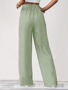 Rear view detail of high-waisted wide-leg pants with green and white vertical stripes