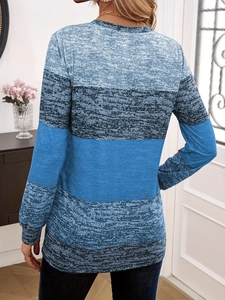 Rear view of women's long-sleeve knit shirt featuring blue color-block patchwork design