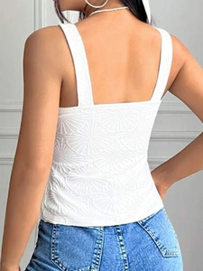 Close-up of white camisole top featuring unique 3D floral jacquard texture and back detail