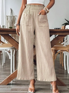 Beige high-waisted wide-leg cotton linen trousers with elastic waist and large front pockets