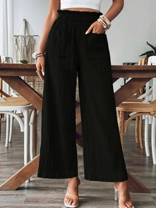 Women's black high-waist wide-leg trousers with pleated texture and utility pockets