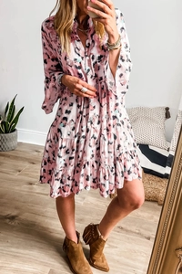 Detail of pink tie-dye tiered dress with V-neck button down and loose sleeves