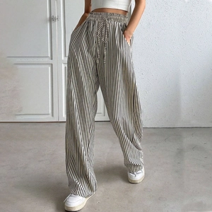 Women's high waisted wide leg trousers featuring vertical black and white stripes