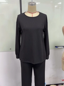 Close-up of black ribbed fabric texture on casual long-sleeved two-piece lounge set