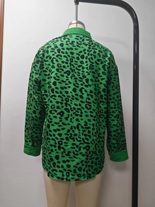 Detail of green leopard print corduroy jacket with button cuffs and loose fit design