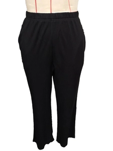 Detailed macro view of black ribbed elastic high-waist pants with a straight-leg cut