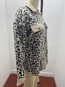 Detail of leopard print corduroy jacket with front pockets and button-up texture