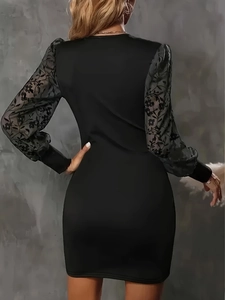 Detail of the slim fit dress with elegant sheer mesh sleeves and floral embroidery