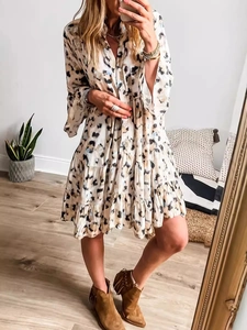 Women's leopard print tiered mini dress with V-neck and button closure in casual style