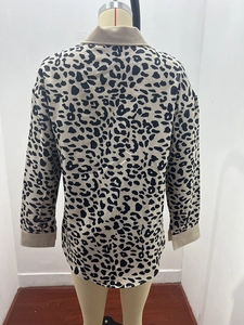 Detail view showing beige corduroy collar and cuffs on leopard print long sleeve jacket