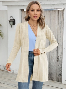 Detailed macro view of cream cardigan sleeve with decorative buttons and wavy fabric texture