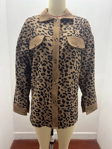 Detail showing leopard print corduroy texture and button pockets on autumn jacket