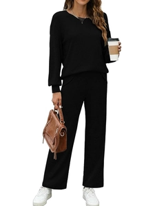 Women's black ribbed loungewear set featuring long sleeve top and wide leg pants