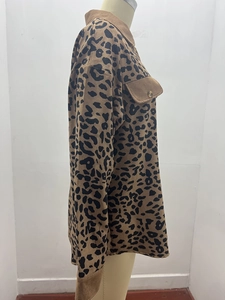 Detail of leopard print corduroy jacket featuring flap pockets and buttoned cuffs