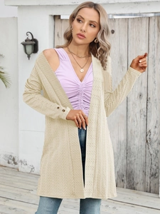 Detail showing the textured beige knit fabric and button cuffs of this women's cardigan