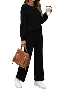 Women black two-piece knit set with long sleeve top and high waist wide leg pants