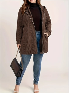 Detail of dark brown textured hooded jacket with ripple pattern and metal zipper closure