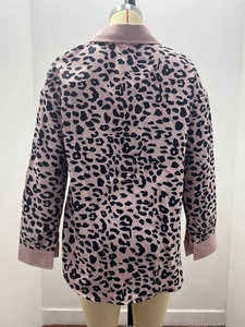 Detail view of pink leopard print corduroy jacket featuring a ribbed texture and lapel