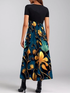 Rear view of an elegant patchwork maxi dress featuring a floral print and flared skirt