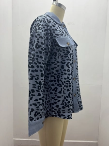 Detail of light blue leopard print corduroy jacket featuring classic button pockets