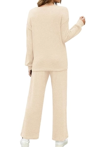 Back view of beige ribbed loungewear set featuring long sleeves and wide leg trousers