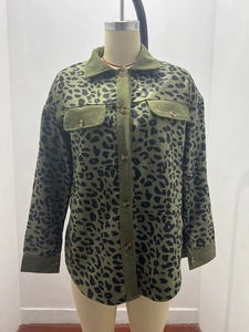 Close-up of army green leopard corduroy jacket texture with buttons and chest pocket
