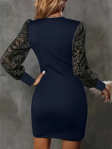 Detail of slim fit dark blue mini dress featuring sheer black floral lace long sleeves