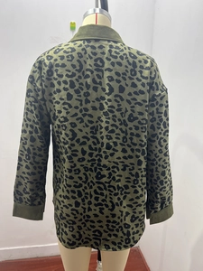 Detail of olive green corduroy jacket showing black leopard print pattern and back texture