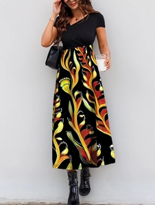 Elegant black V-neck patchwork dress with bright floral print skirt and short sleeves