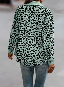 Macro detail of mint green leopard print corduroy jacket fabric with clear texture