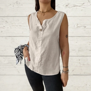 Macro detail of breathable cotton linen fabric texture and wooden button on the beige top