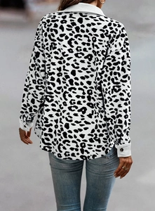Detail of black and white leopard print jacket with textured fabric and buttoned cuffs