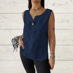 Detail of navy blue V-neck linen tank top featuring single button and loose sleeveless fit