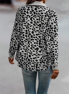Detail of leopard print corduroy jacket showing ribbed texture and buttoned cuff design