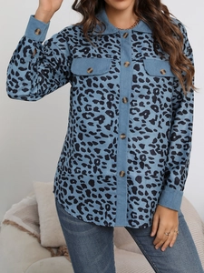 Detail of blue leopard print corduroy jacket showing textured fabric and chest pockets