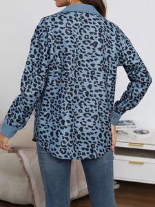 Rear view of a blue leopard print button jacket with corduroy texture and curved hem