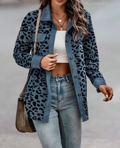 Detailed texture of blue corduroy leopard print jacket with buttons and collar