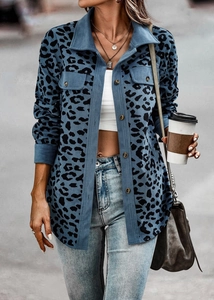 Close-up of blue leopard print corduroy jacket featuring chest pockets and button detail