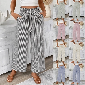 Detail showing high waisted striped wide leg pants with paper-bag waist and tie belt
